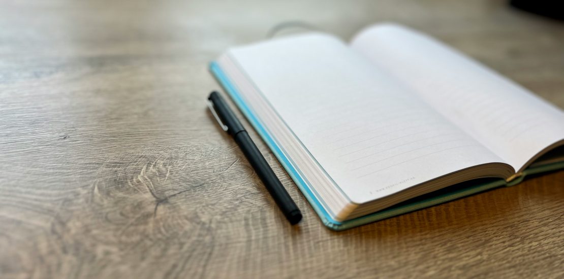 Calm notebook on desk symbolising a gentler workday, navigating difficult times at work